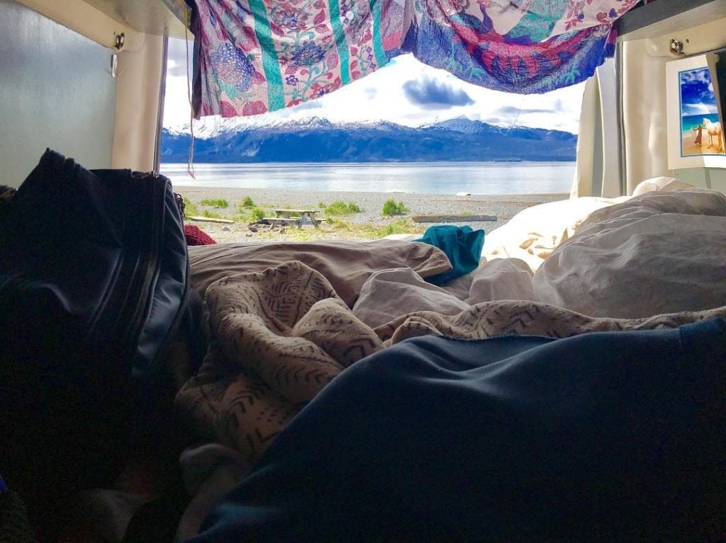 Van life is helping Sarah pay off her debt. Click here to learn more about living in a van and how she built her van dwelling. #vanlife #vandwelling #vanlifehacks #vanlifeDIY #vanlifeideas