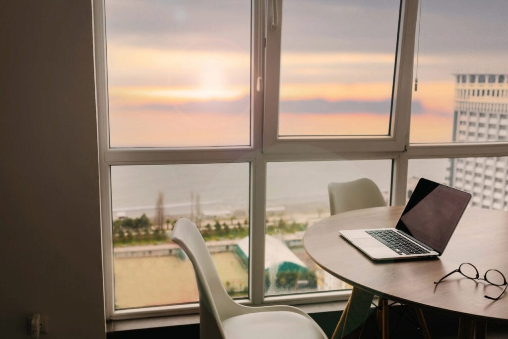 Perfect freelance workspace with sea and sunset for article 12 Surprising Work From Home Jobs You've Probably Never Heard Of